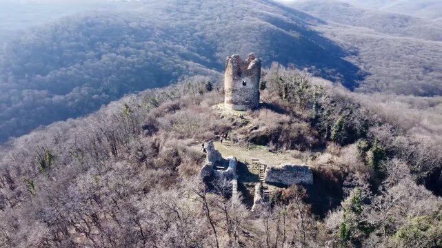 Aerial view of Vrdnicka Kula medieval tower ruins in Fruska Gora, Serbia, surrounded by forested hills. g.