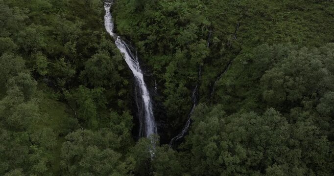 Very tall waterfall on a Scotland highlands mountainside on isle of skye