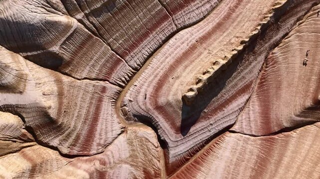 Aerial view of the unique colorful sedimentary rock layers and eroded desert terrain of Kyzylkum, Mangystau Region, Kazakhstan.