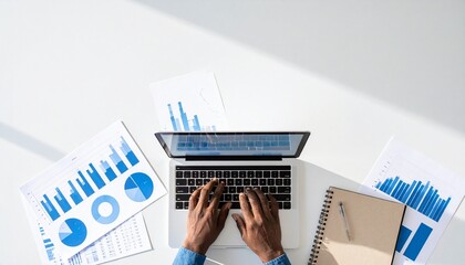 Laptop user analyzing charts with business data visualization overlay