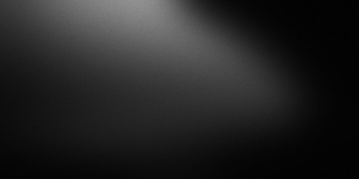 Elegant spotlight effect hitting grainy dark grey surface creating dramatic contrast and depth for professional photography backdrop.