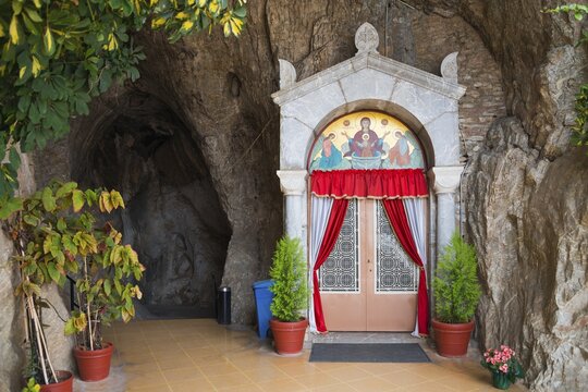 Church entrance in rock face with red curtains and icons, Church of Mary the Fountain of Life, Zoodochos Pigi, rock church, Kefalari, Argolis, Peloponnese, Greece