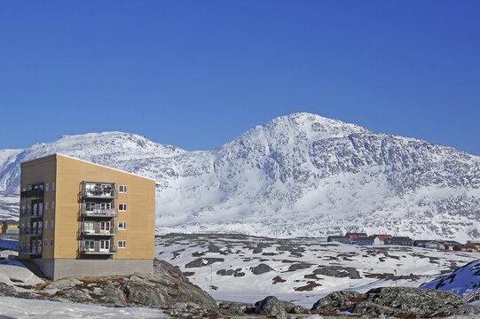 Apartment block and rugged, snowy mountain landscape, capital, Nuuk, Arctic, North America, Greenland, Denmark