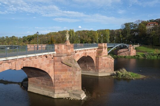 Historic stone bridge over a river with clear sky and autumn vegetation, P&ouml;ppelmannbr&uuml;cke, River Mulde, Grimma, Leipzig, Saxony, Germany