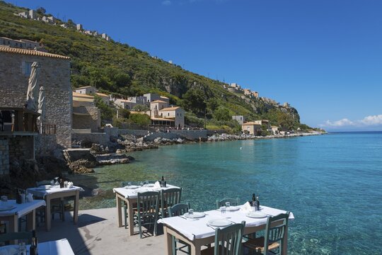 Relaxing coastal view with Mediterranean buildings on a rocky coast by the clear blue sea, Limeni, Areopoli, Laconia, Peloponnese, Greece