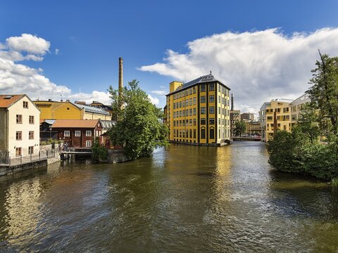 Former factory building Styrkj&auml;rn on the island of Laxholmen in the Motala str&ouml;m river, Arbetets Museum, Museum of Work, Industrial Landscape in the City Centre, Norrk&ouml;ping, &Ouml;sterg&ouml;tland, Sweden