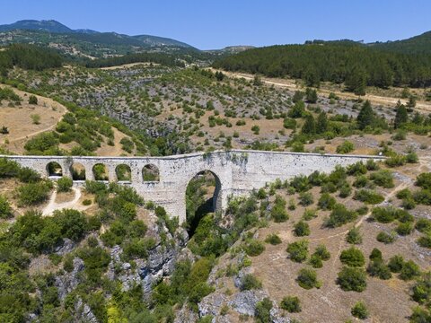 Historic stone aqueduct stretches across a green, hilly landscape, aerial view, Incekaya Aqueduct, Tokatli Gorge, Safranbolu, Karab&uuml;k Province, Anatolia, Turkey