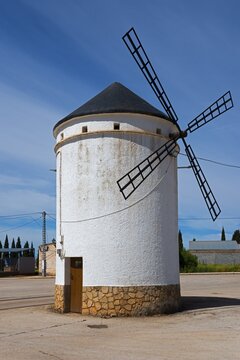 Small white windmill with blades and stone base under a clear sky, Mill, Molino de Villahermosa, La Mancha, Ciudad Real, Castilla-La Mancha, Spain