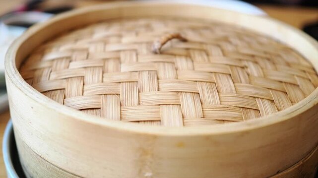 Steaming food in a bamboo basket in a kitchen