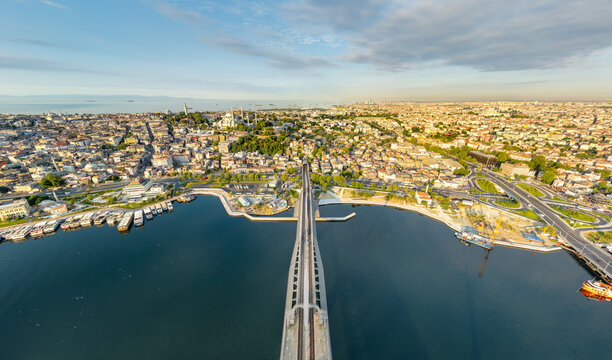 Istanbul, Turkey. Halic Metro Bridge going into tunnel under Fatih district, aerial view of metro line and panoramic cityscape at sunrise. Aerial view