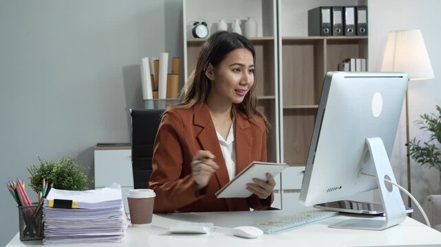 Young Asian woman in suit works confidently in office as business consultant, providing strategic advice, analyzing market trends, financial stability for corporate clients and organizations.