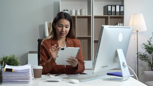 Young Asian woman in suit works confidently in office as business consultant, providing strategic advice, analyzing market trends, financial stability for corporate clients and organizations.