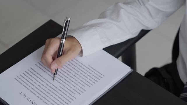 Lawyer checking documents and typing on laptop