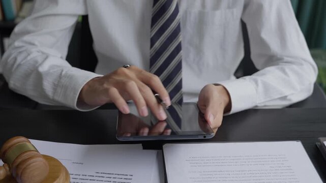 Lawyer using tablet checking legal document in office room