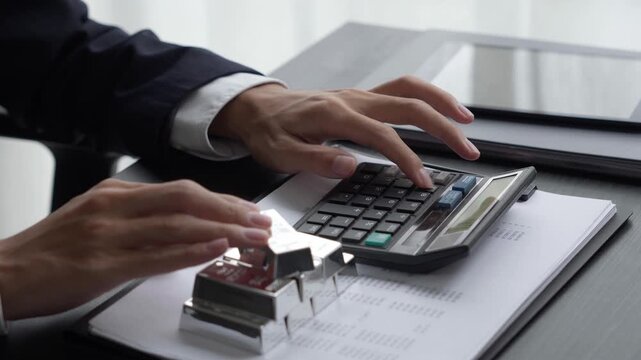 Asian businessman using calculator calculate silver price