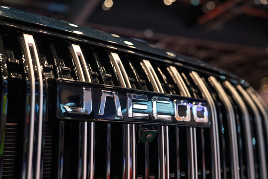 Penang, Malaysia - May 2, 2026: A close-up shot of the silver chrome Jaecoo wordmark emblem integrated into a prominent vertical-slat front grille of an SUV at an exhibition hall.