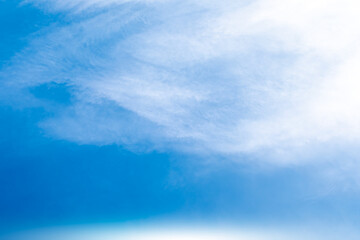 Obraz premium A bright, clear blue sky meets a glowing white horizon, suggesting a serene, open, and with sunlight of beautiful cloudy sky. landscape or abstract background 