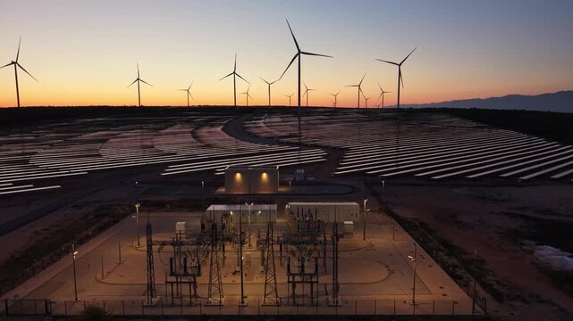 Aerial view of VP Korlat wind and solar farm with a power substation and rows of panels under a sunset sky in Korlat, Zadarska zupanija, Croatia.