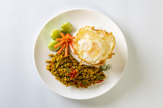 Rice topped with Southern-style yellow curry pork and a fried egg.