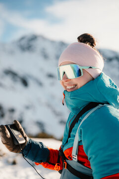 Ski alpinist in the mountains. Ski touring in alpine landscape with holding a modern avalanche beacon in his hands. Off piste skier in Low Tatras, slovakia