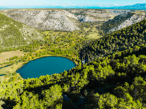 Aerial view of the confluence where the Cikola river lake drom torak view tributary joins the Krka river canyon, Krka National Park, Dalmatia, Croatia.