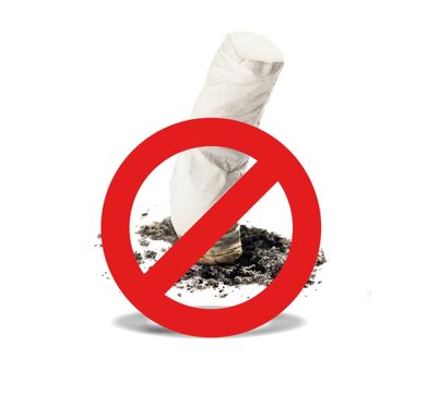 Cigarette butt with ash under a red prohibition sign