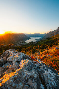 Stunning aerial panorama of the Bay of Kotor from the famous Kotor Serpentine road, featuring the turquoise Adriatic sea, coastal towns, and rugged limestone mountains, Montenegro.