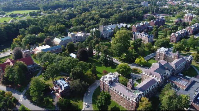 Aerial view of Vassar College campus featuring historic collegiate gothic architecture and lush green trees in Poughkeepsie, New York, United States.