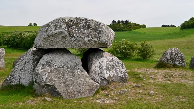 Stone age ruins in a field under cloudy skies.