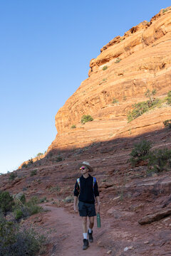 Young man explores a scenic red rock hiking trail