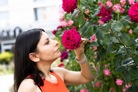 Woman in a garden with roses in the city