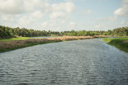 Wide river winding through a grassy Florida marshland
