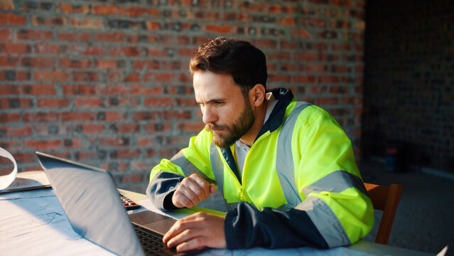 Architect, man or laptop review on construction site for digital design, report draft or planning. Architecture, person and tech on blueprint outdoor for building code, project progress or compliance