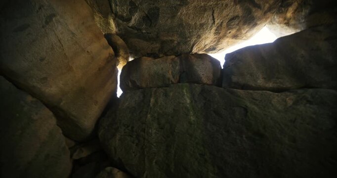 Interior of stone structure with sunlight poking through - steady cam shot