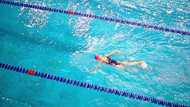 An intensive swim training session in an indoor sports pool. 
