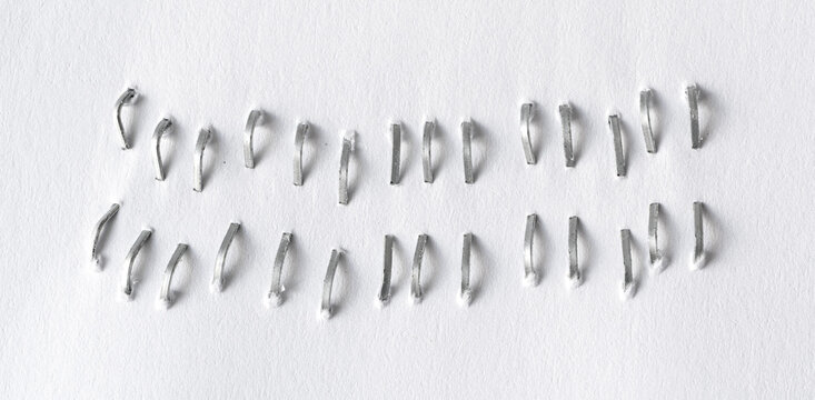Staples pushed into a paper, metal office staple needles