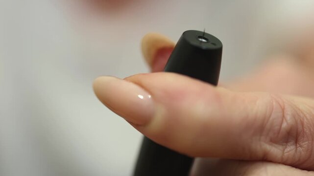 Glucometer. Needle. Fingers. Lancing device. Slow motion video. High quality 4k footage
