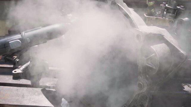 cleaning and washing with a steam cleaner of an old manual transmission from a front-wheel drive car for repair