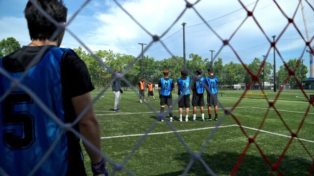 Soccer players jumped together during training to practice defensive tactics by forming a wall to protect the goal from free kicks. This demonstrates teamwork and athletic performance on the field