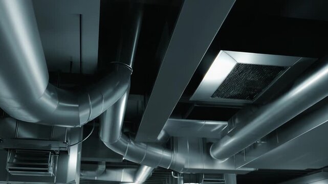 Complex industrial hvac system ductwork and ventilation pipes creating an intricate network on a building ceiling, ensuring climate control and air circulation