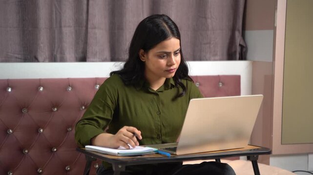 Indian woman attending online class or working from home on laptop at home