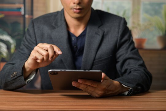 Man in Suit Using Tablet for Business and Technology Communication