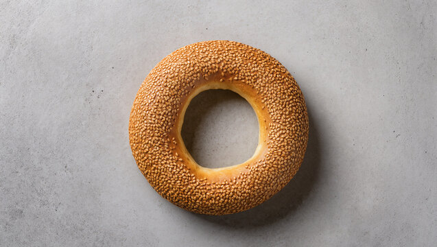 Top view of traditional Turkish simit or sesame bagel bread on a grey concrete background