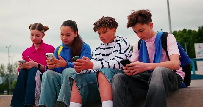 Group of teenagers absorbed in their smartphones