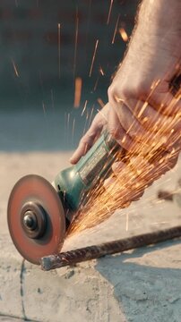 Architect, hands and construction with grinder on steel rebars for reinforcement or civil engineering. Person, builder or metal sparks for building maintenance, structure safety or security on site