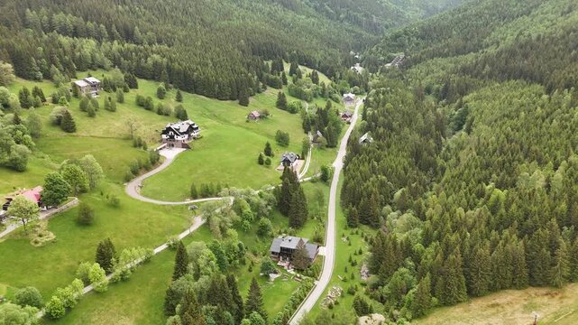 Aerial view of mountain house in misty spruce forest in Krkono&scaron;e Mountains Czech Republic