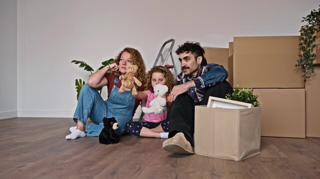 Tired family playing with puppets after moving to a new home