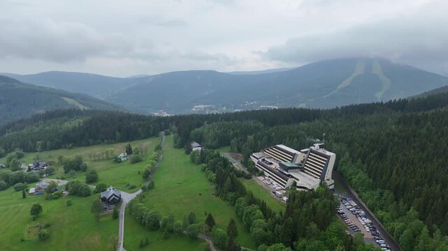 Aerial view of mountain house in misty spruce forest in Krkono&scaron;e Mountains Czech Republic