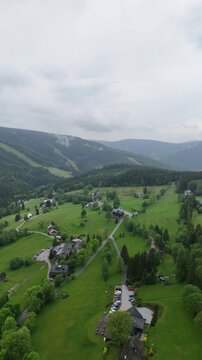 Aerial view of mountain house in misty spruce forest in Krkono&scaron;e Mountains Czech Republic