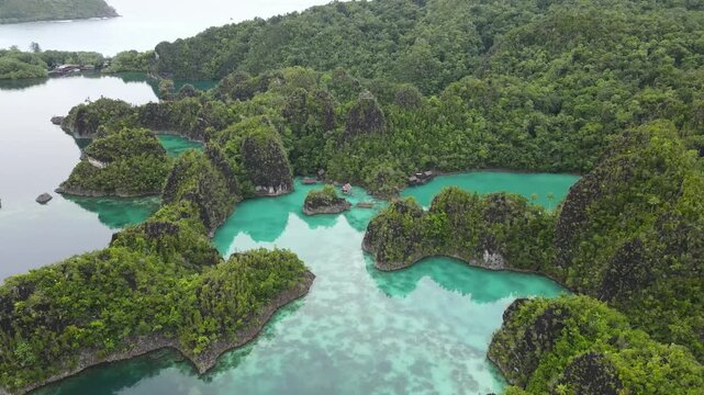Aerial view of tropical limestone karst islands surrounded by crystal clear turquoise water in Raja Ampat
